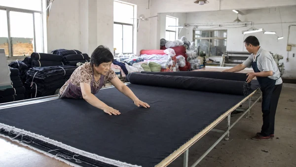 Fabric being prepared on a cutting table