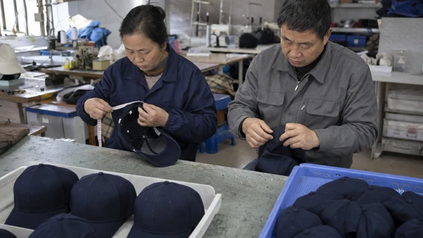 Workers reviewing cap construction and finishing